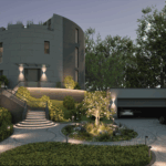 Rundbau-Villa mit moderner Garten- und Außenbeleuchtung in der Dämmerung, elegante Zufahrt mit Garagen und hochwertiger Pflasterung.